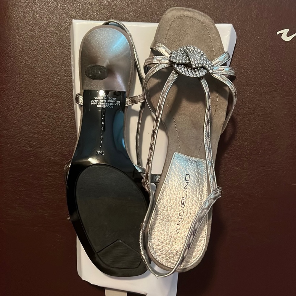 Dressy silver 2 1/2” heels with rhinestone center flower.